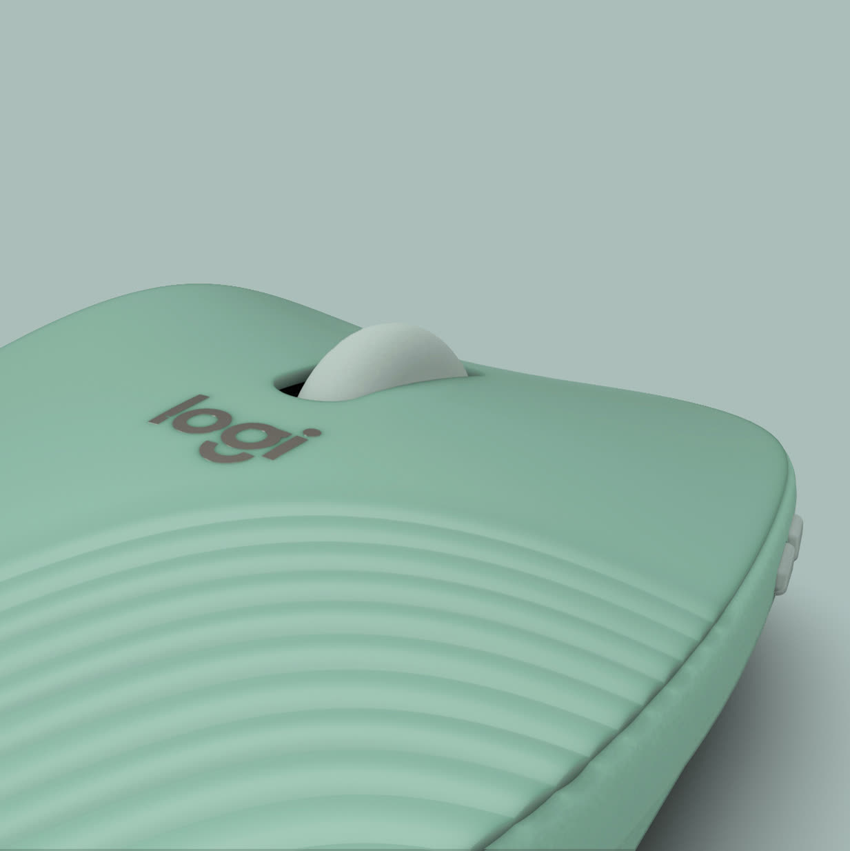 Close-up of the sage-green mouse, its logo and the wave-textured shell